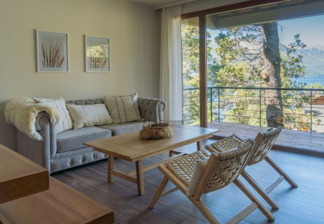 Living room in Lenga 1D apartment with balcony access and a bright interior.